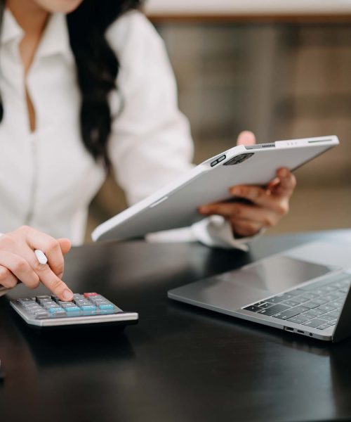 businesswoman-using-on-smartphone-and-tablet-and-l-AH92EXP.jpg